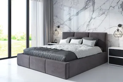 A modern bedroom with a large bed, marble walls, and large windows.