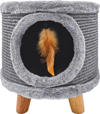 A small cat scratching post with a hanging feather toy inside.