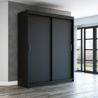 A black sliding door wardrobe is shown in a room with a concrete wall and wooden floor.