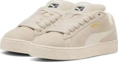 A pair of beige Puma Suede XL Uni sneakers.