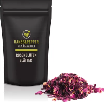 A black pouch of dried rose petals next to a pile of rose petals.