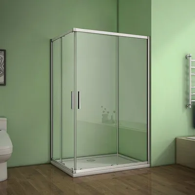 A modern bathroom with a corner shower enclosure, toilet, and wooden floor.
