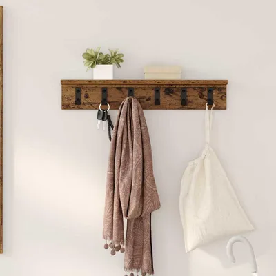A wooden shelf with hooks mounted on a white wall, displaying keys, a scarf, and a bag.
