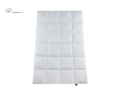 A white down comforter is laid flat on a white background, showing its quilted pattern.