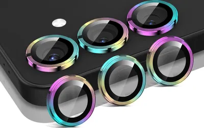 Several camera lens protectors with rainbow-colored rims are arranged on a black surface, likely a phone.