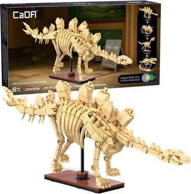 A product box and a model of a Stegosaurus skeleton.