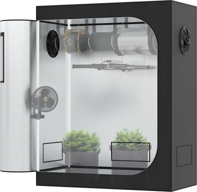 A grow tent with plants inside, showing ventilation equipment.