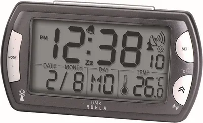 A digital alarm clock is shown from a front-facing angle against a light gray background.