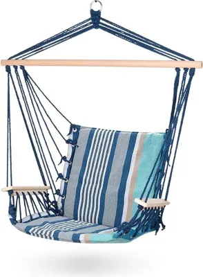 A hanging chair with a striped cushion, suspended from a wooden bar.