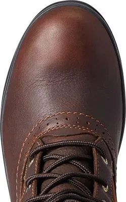 Close-up view of the toe and laces of a brown leather boot.