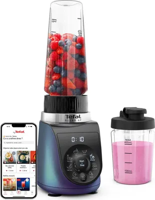 A Tefal Blend Up mini-mixer with a cup of fruit, a separate cup with a smoothie, and a smartphone displaying recipes.