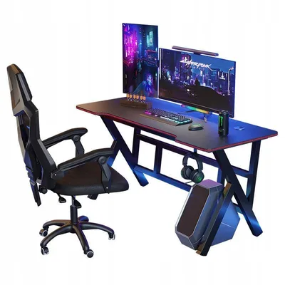 A gaming desk setup with a chair, computer, and monitors.