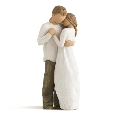 A figurine of a couple embracing.