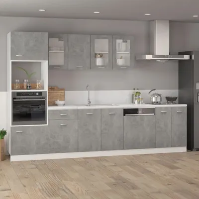 A modern kitchen with gray cabinets and a white countertop.
