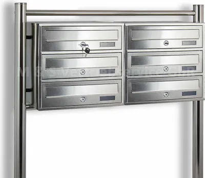 A set of six stainless steel mailboxes mounted on a metal frame.