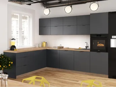 A modern kitchen with dark gray cabinets and wooden countertops.