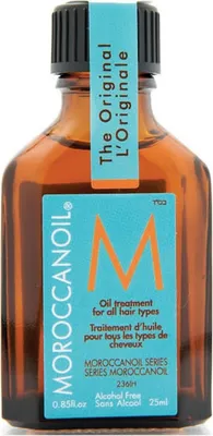 A small amber glass bottle of Moroccanoil hair treatment with a turquoise label.