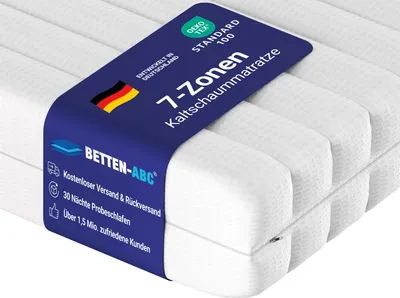 A close-up view of a white mattress with a blue band wrapped around it, featuring product information and branding.