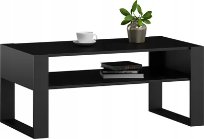 A black coffee table with a shelf, a coffee cup, and a plant on top.