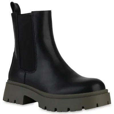 A black Chelsea boot with a thick, olive green lug sole is shown against a white background.