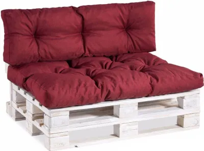 A burgundy pallet sofa cushion set on a white wooden pallet.
