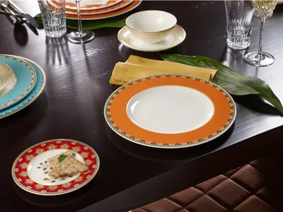 A table setting with multiple plates, glasses, and napkins.