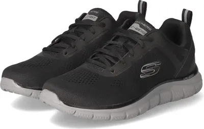 A pair of black Skechers sneakers with gray soles.
