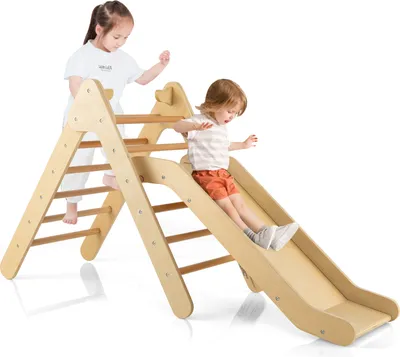 Two children playing on a wooden climbing triangle with a slide.