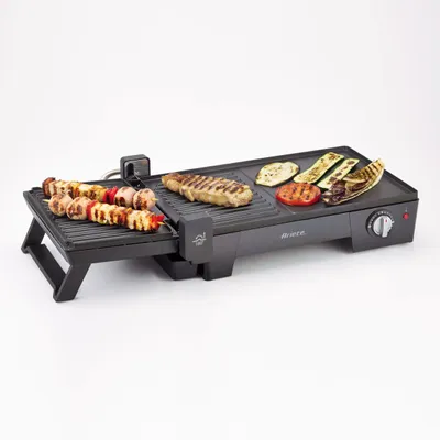 A black electric grill with food on it, set against a white background.