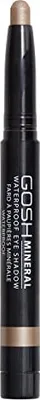 A close-up studio shot of a black and gold eye shadow stick.