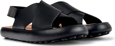 A pair of black Camper sandals on a white background.