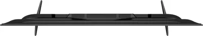 A top-down view of a black television with its stand legs attached.