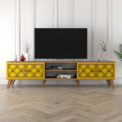 A TV stand with a television on top, placed in a room with white paneled walls and a wooden floor.