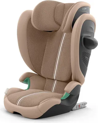 A studio shot of a beige car seat against a white background.