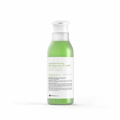 A green shampoo bottle with a white cap and label, isolated on a white background.