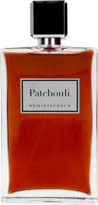 A perfume bottle with a black cap and a clear glass body containing orange-colored liquid.