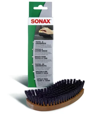 A Sonax textile and leather brush with its packaging.