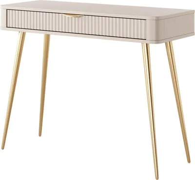 A beige console table with a fluted drawer and gold legs against a white background.