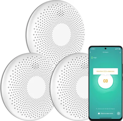 Three white circular CO detectors are arranged in a cluster, with a smartphone displaying a CO alarm notification next to them.