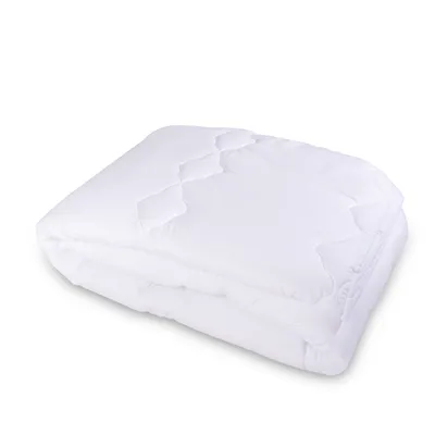 A folded white comforter and pillow set on a white background.