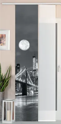 A sliding panel curtain with a black and white image of the Brooklyn Bridge at night, with the moon visible.