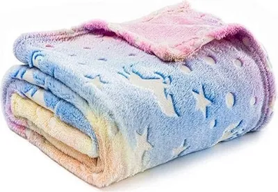 A folded blanket with a unicorn and star pattern.