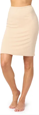 A woman's legs wearing a beige slip.