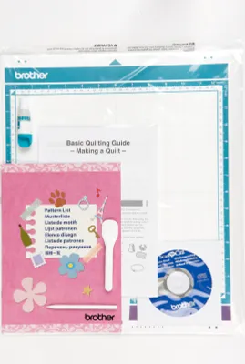 The image shows a Brother ScanNCut CM600 Hobbyplotter kit, including the cutting mat, a guide, a CD, and various accessories, all contained within its original packaging.