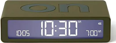 A digital alarm clock with a khaki-colored body and a blue display showing the time.