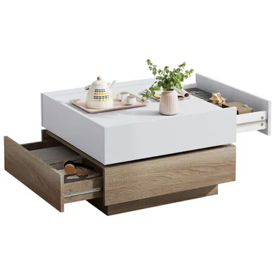 A modern coffee table with a white top and wood-grain base, featuring two open drawers.