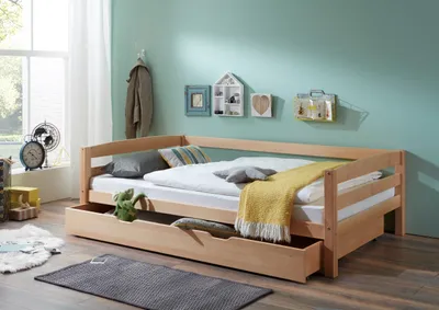 A wooden daybed with a pull-out drawer in a bedroom setting.