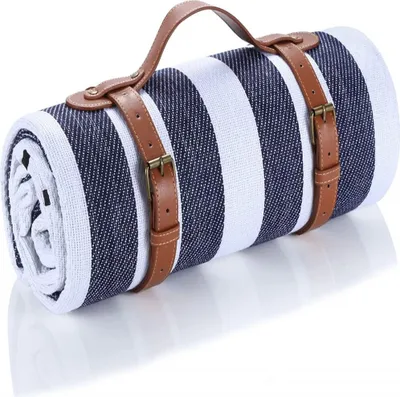 A rolled-up picnic blanket with blue and white stripes and leather straps.