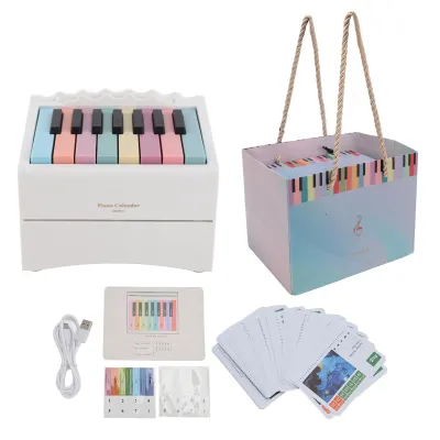 A collection of items related to a piano-themed calendar, including the calendar itself, a gift box, and cards.