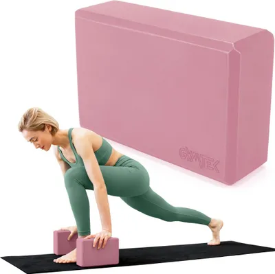 A woman is performing a yoga pose on a mat, with yoga blocks placed under her hands. A large pink yoga block is shown in the background.